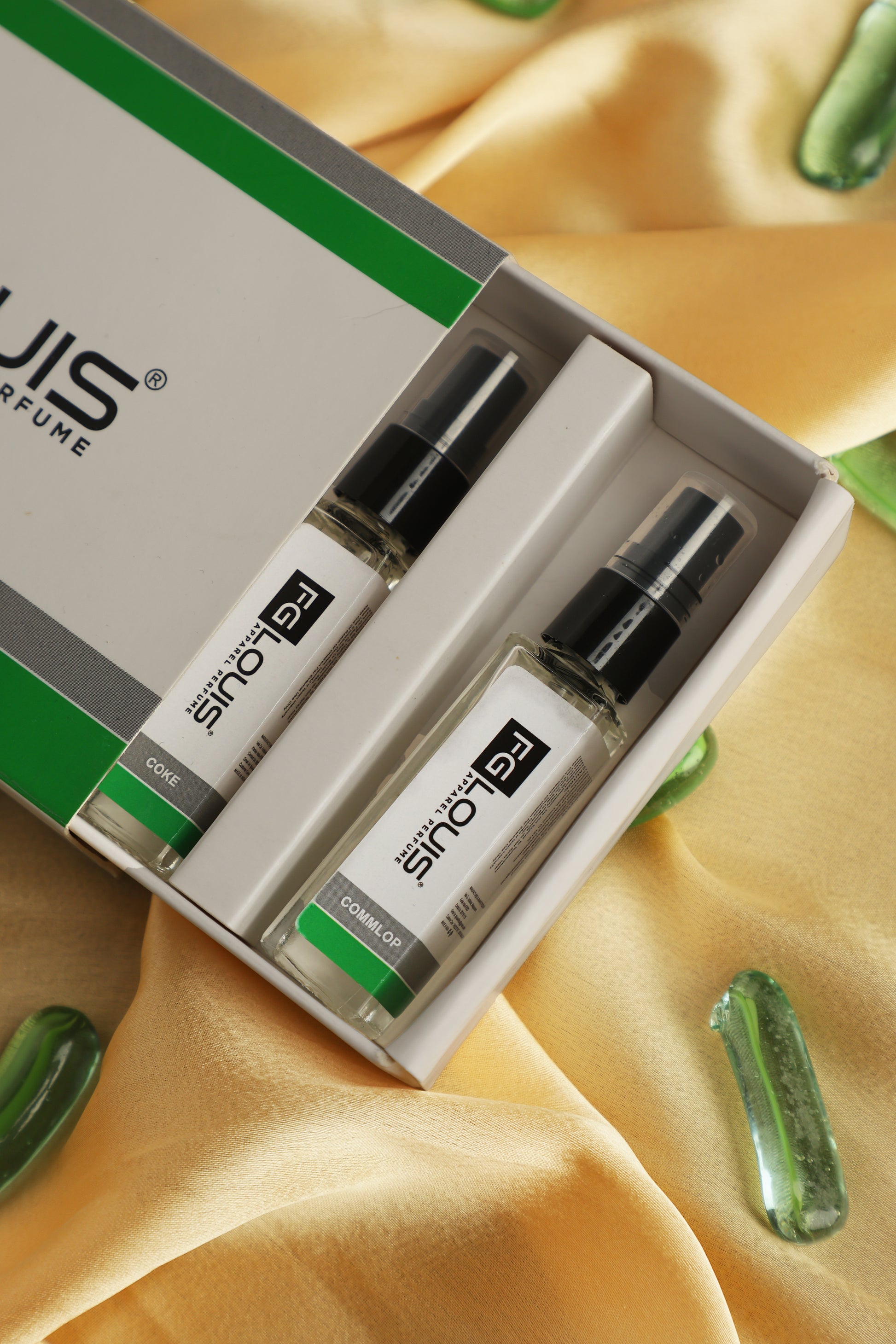 SINOTEC perfume set with green and white packaging on a yellow fabric background